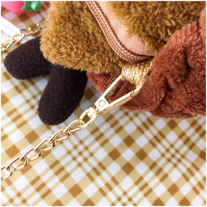 Detail of soft brown plush squirrel bag with golden chain strap and lobster clasp
