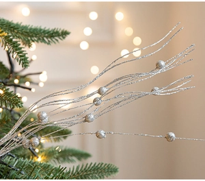 Macro detail of silver Christmas tree branch with glitter coating and mini beads