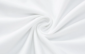 Close-up of white soft fabric texture with elegant pleated spiral fold detail