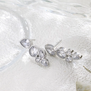 Close-up of teardrop cluster cubic zirconia studs with polished silver finish