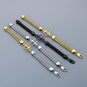 Macro detail of stainless steel anchor bracelets in gold, silver, and black finishes