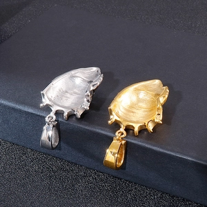 Detailed close-up of hip-hop lion head pendants in gold and silver steel finish