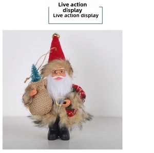 Detailed view of Santa Claus figurine with gold glasses and a mini tree in burlap bag