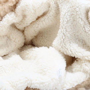 Close-up of thick white faux shearling lining and material wash label on a winter hat