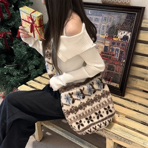 Detail of plush jacquard bucket bag with Nordic snowflake pattern in cozy Christmas scene