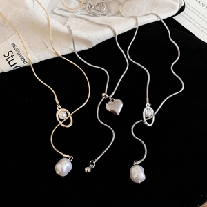 Three minimalist heart and pearl pendants on fine snake chains in gold and silver