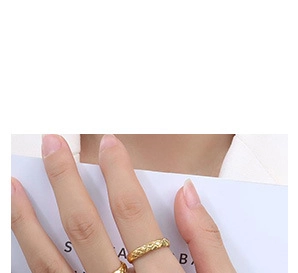 Macro detail of gold quilted texture ring band featuring elegant coco crush pattern