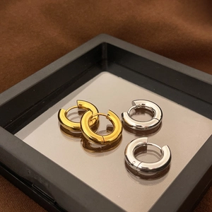 Polished chunky 18k gold and silver stainless steel hoop earrings in a display box