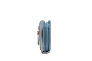 Detail view of grey-blue leather wallet showing the layered structure and golden buckle