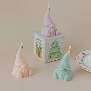 Handmade Santa Claus gnome scented candle in pastel colors with gold bell and gift box
