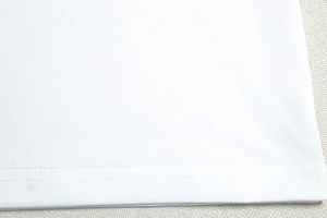 Gros plan sur la texture du tricot blanc et les détails de couture sur l'ourlet
