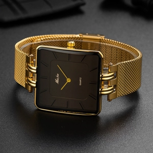 Close-up of square gold quartz watch with black dial and Milanese mesh steel strap