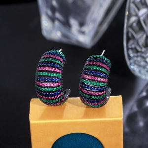 Detailed close-up of C-shaped earrings with colorful gradient zircon on black metal base