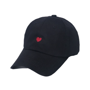 Classic black cotton baseball cap featuring a small red embroidered heart on the front