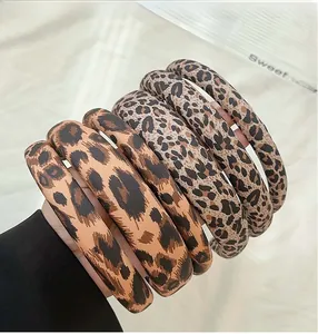 Set of five wide leopard print sponge headbands in various brown and beige shades