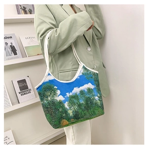 Close-up of artistic oil painting canvas tote bag worn on shoulder in daily casual setting