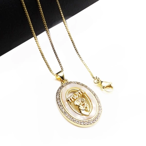 Close-up of gold heart MOM necklace with shell inlay and cubic zirconia stones