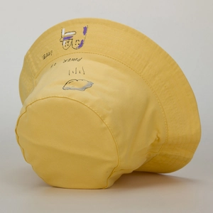 Detail of yellow cotton bucket hat featuring hand-drawn graffiti and Power of Love text