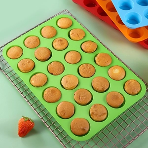 24-cavity silicone mini muffin pan in green, blue, and red for high-heat baking