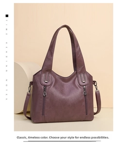 Detailed view of the purple faux leather texture and dual vertical zipper pockets