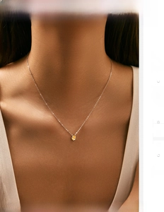 Close-up of S925 silver necklace with a yellow pear-cut gemstone pendant on neck