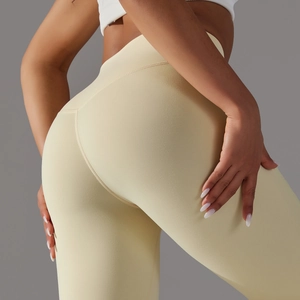 Detail showing high-waist yoga leggings with curved butt-lifting seams in pale yellow