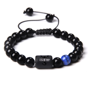 Adjustable woven beaded bracelet with black beads and Scorpio zodiac cylinder charm
