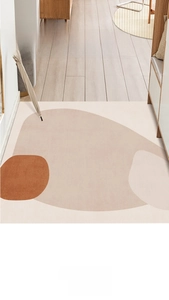 Top-down view of abstract Morandi geometric entryway mat in a home hallway setting