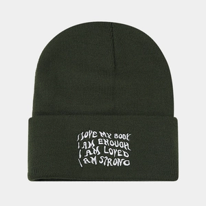 Detailed embroidery on dark green knit beanie with positive slogan lettering