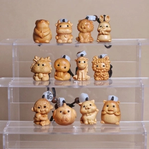 Detailed view of hand-carved cedar wood zodiac figures on a multi-tier acrylic display stand
