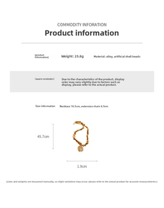 Detail of beaded necklace featuring brown faux shell beads and golden hollow round pendant