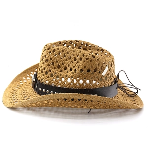 Detail of the woven straw cowboy hat featuring metal studs on a brown leather band