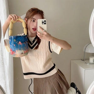 Detail of artistic canvas bucket bag with yellow quilted bubble handle and cute illustration