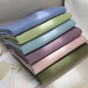 Solid color cashmere-feel scarf for women in multiple soft tones stacked neatly