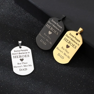 Detailed view of silver, black and gold engraved stainless steel military tags for Dad