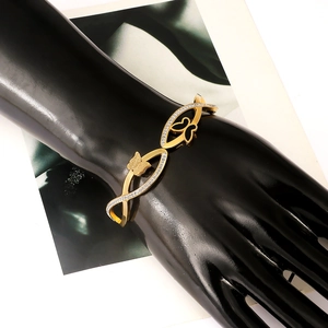 Sparkling gold butterfly bangle for women with cubic zirconia on black hand model