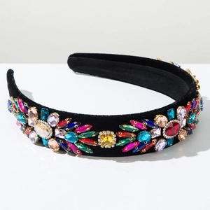 Macro shot of Baroque velvet headband with colorful rhinestones in golden metal settings