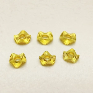 Detailed view of six gold wave pattern spacers for DIY jewelry making accessories