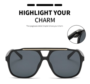 Detailed view of black aviator sunglasses featuring a gold metal bridge and sturdy hinge