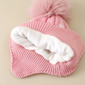 Pink winter knit hat for girls with ear flaps, faux fur pom and warm fleece lining