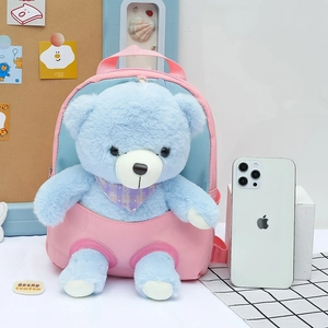 Pink and blue children's backpack featuring a cute blue plush bear with a purple scarf