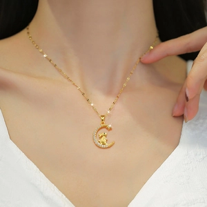 Golden titanium steel necklace with moon and rabbit pendant worn by a model