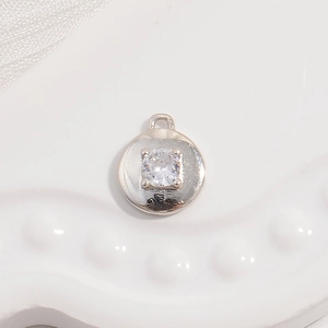 S925 sterling silver round pendant with clear cubic zirconia on a white display tray