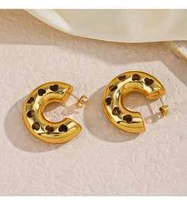 Detailed view of 18K gold plated heart cut-out hoop earrings on beige silk fabric
