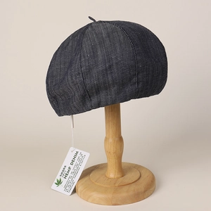 Close-up of dark grey hemp denim baker boy hat texture with natural material tag