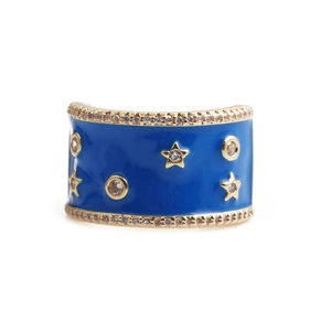Close-up of blue enamel star ring with sparkling cubic zirconia on gold base