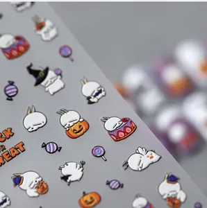 Detailed macro view of 5D Halloween nail art stickers featuring cute bunny and pumpkin