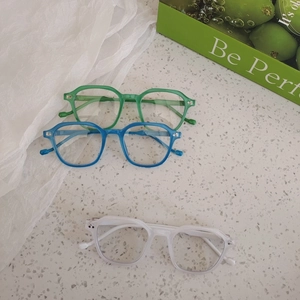 Kids trendy square frame sunglasses with rivet accents in green, blue, and clear colors