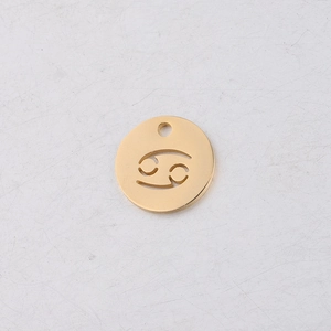 Macro detail of 12mm golden titanium steel round pendant with hollow Cancer zodiac symbol