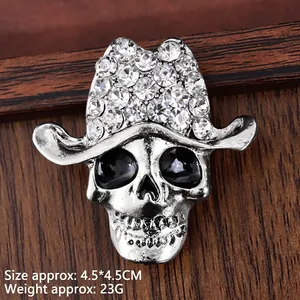 Vintage silver skull cowboy brooch with rhinestones and black enamel detail